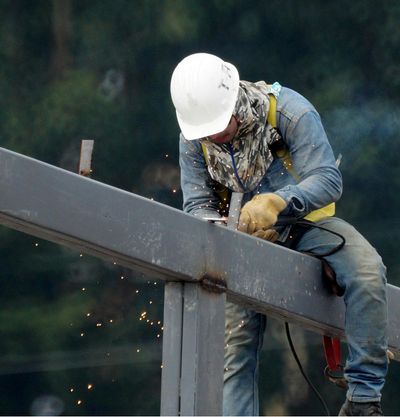 Benchmark One General Contracting construction worker welding metal frames for a commercial project