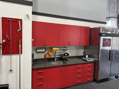 Custom red cabinetry installed by Benchmark One General Contracting